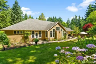 This expansive acreage has been thoughtfully designed for low maintenance, featuring beautiful perennials at every turn and ample garden space to make your own.