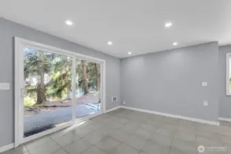 Spacious living room with sliding glass door to private patio in Bothell townhome.