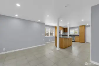 Eating island, granite counters, and open layout to living room.