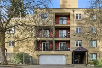 Front of building with garage access and lobby entrance.