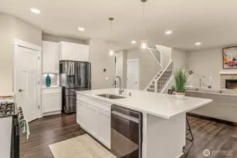 Stunning kitchen has recessed lighting to and beautiful surfaces throughout