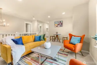 Loft rec room has abundant natural light and space for fun. Recessed lighting and big windows.