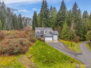 Follow the long private drive to get away from it all to your own little forest on 5 and 1/2 acres