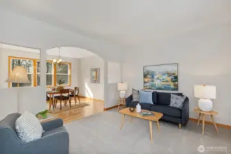 The living room flows seamlessly into the formal dining room, creating an ideal space for gatherings and entertaining.