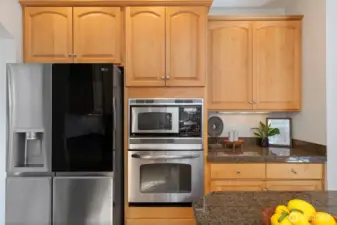 The kitchen is equipped with sleek stainless steel appliances for a modern, polished look.