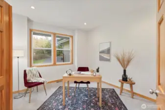 The flexible downstairs den/office provides the ideal space for remote work, hobbies, or additional living needs.