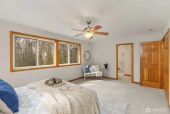 Step through elegant solid wood French doors into the spacious, light-filled primary suite, complete with a private en suite bathroom for a serene and comfortable retreat.