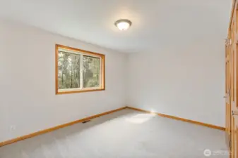 Large bedroom at the top of the stairs, perfect for a bedroom, office, or bonus space.