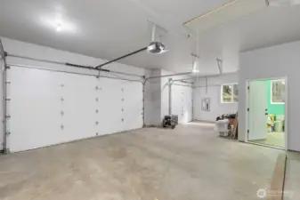 Spacious 772 sq. ft. attached three-vehicle garage with an integrated workshop.