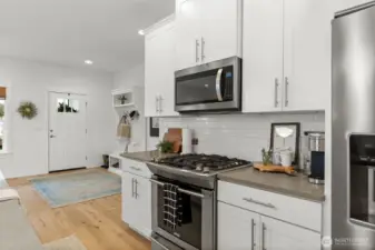 White cabinetry, stainless appliances, and thoughtful finishes