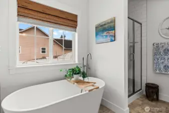 Freestanding soaking tub with bright natural light
