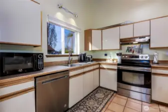 Open kitchen with ample storage, quality appliances and functional workspace.