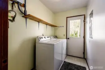 Convenient laundry room with direct access to the backyard.