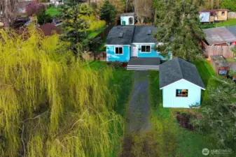 Bright aerial view featuring the home’s welcoming façade.
