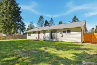 Back of the home with oversized yard. Note the new gate and fencing on the right.