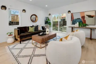 Sunlit living space enhanced by custom lighting and light flooring that creates striking contrast.