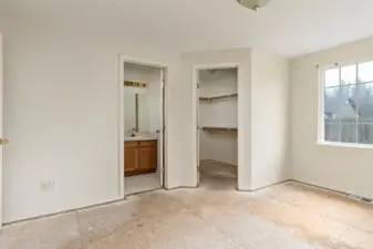 Primary bedroom with walk in closet and en suite bathroom.