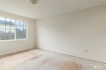 Primary bedroom with window facing the backyard.