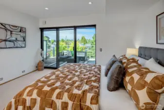 The expansive primary bedroom offers sliders to a private, vast deck with a territorial view, creating an ideal oasis of tranquility and an indoor/outdoor living experience.
