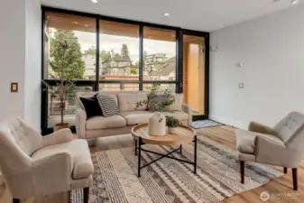 Enjoy a majestic open-concept living area with floor-to-ceiling windows that flood the space with natural light, complemented by new LVP flooring with radiant heating throughout the living area.