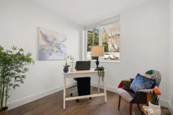 Lower Level- Office, den or extra bedroom (does not have closet, but could be a third bedroom) with beautiful engineered hardwood floors, lots of natural light, beautiful flower garden right outside window; perfect for work from home or relaxing while gaming
