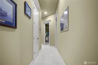 Hallway leading to other bedrooms, den/office, and full bathroom