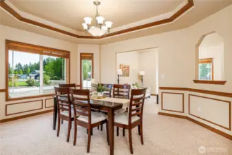 Spacious Formal Dining Room looking towards the front Living Room. Note the custom wood coffered ceiling and chair rail.