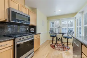 Charming breakfast nook has bright windows. Microwave and gas range/stove are just a few years old.