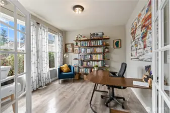 Office with French doors offers a versatile space. Abundant natural light and thoughtful layout provide both comfort and functionality.