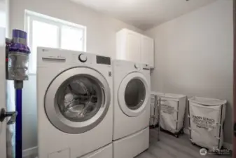 The upstairs laundry room features plenty of space and a surprise...