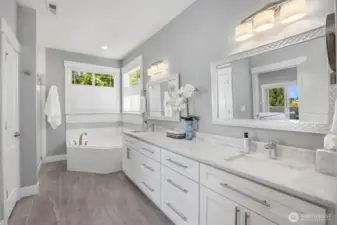 Primary Bath with separate shower, tub, two sinks and adjacent walk-in closet.