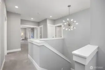 The Elevator to this 3rd level is located to the immediate right, the stairwell is straight ahead and the door to the right leads to a full bath serving the 2nd and 3rd bedrooms on this level.  Wide French Doors beckon you to the Primary Suite also.