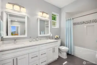 Double sinks and a tiled bath serves the 2nd and 3rd bedrooms.