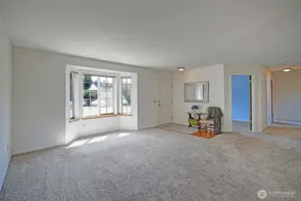 Great living room by the front door with newer carpet and lots of light.