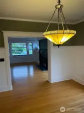 Apt A - Large dining room continues with hardwood floors and an exquisite chandelier.