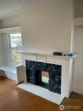 Apt D - A stone fireplace with decorative details adds a beautiful focal point to the room.