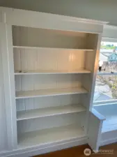 Apt D - Built-in shelving adds extra storage space or a great place to display treasures.