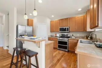 Convenient elevated breakfast bar and corner pantry too
