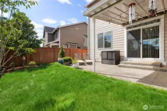 Enjoy the fully fenced yard with patio and lush lawn and mature trees!