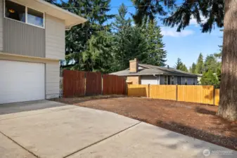 Extra RV & boat parking on the side of the house behind fence.