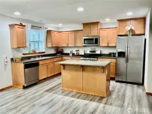 Modern Kitchen with granite countertops, stainless steel appliances.