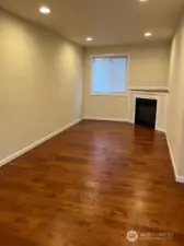 The living room area has a gas fireplace and hard surfaces for ease of living too!