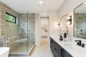 Spa-like primary bathroom with heated floors, elegant fixtures and sophisticated tile selection.