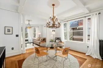 Spacious dining room with wood inlay flooring and gorgeous box-beam ceilings. Generous use of quality millwork throughout the home.