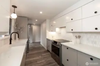 Main Level Kitchen recently remodeled with Quartz countertops, Fireclay farmhouse sink, Kohler Kitchen faucet and Bosch appliances. Carrara marble mosaic backsplash.