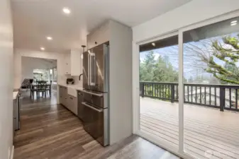 Main Level Kitchen with Slider to deck. All new plumbing & light fixtures throughout home!