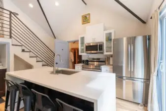 Cottage (Airbnb) Kitchen is light, bright and modern with quartz countertops, and an open concept, stainless steel appliances, a deep sink, expansive island