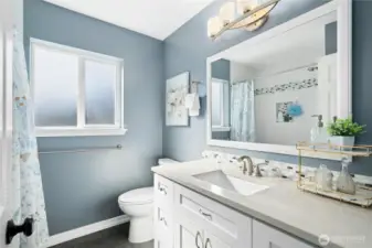 Full bath with tub/shower combo.