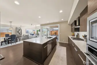 View of dining, great room and covered deck from kitchen