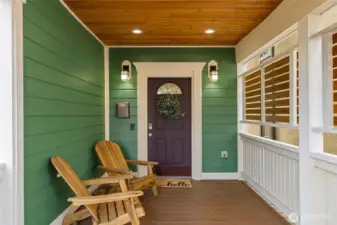 The covered porch has low maintenance composite decking and invites cozy conversation.